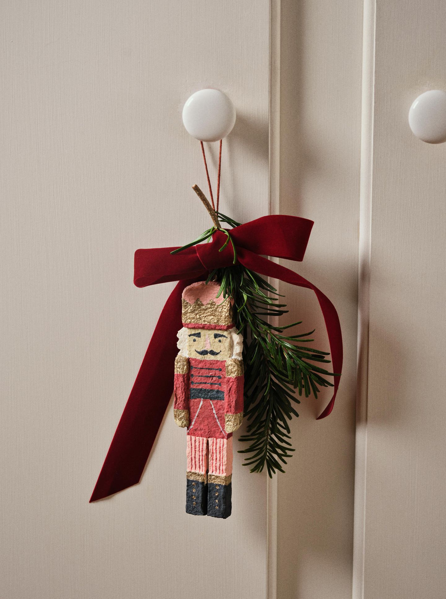 Detailed Wooden Nutcracker Ornament on Pine Branch Detailed Wooden Nutcracker Ornament on Pine Branch — Nutcracker Christmas Tree