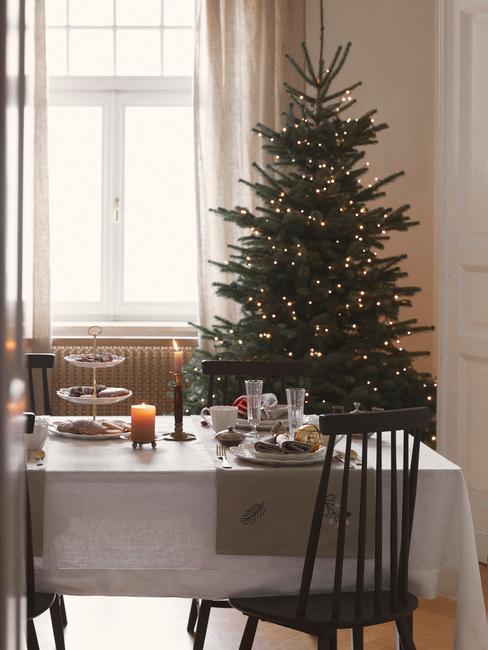 Modern Dining Room Setting with Festive Tree Backdrop — Modern Christmas Decor