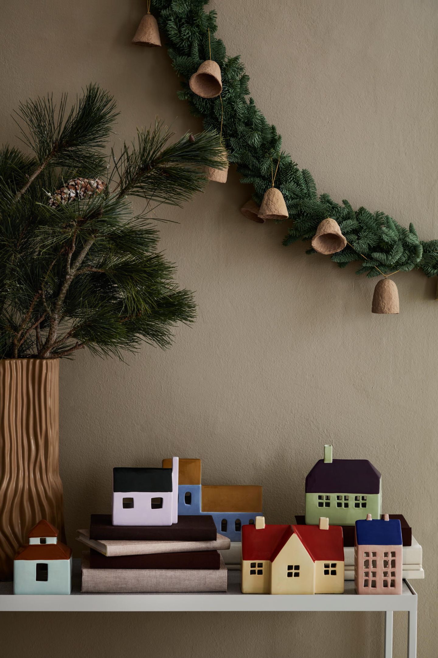 Modern Shelf Display with Pastel Ceramic Houses and Pine Garland — Whimsical Christmas Decor