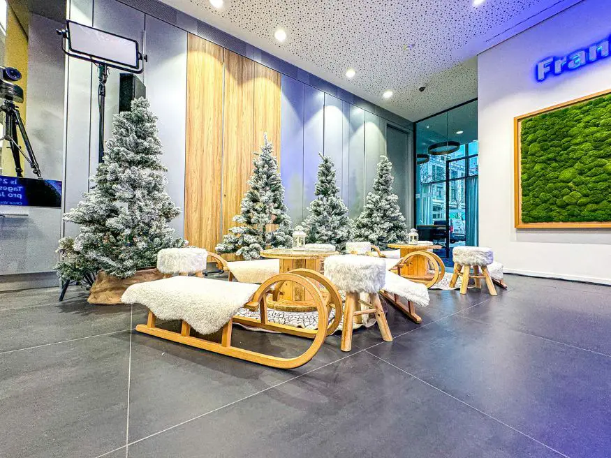 Modern Lounge Area with Miniature Christmas Trees and Sled Seating Modern Lounge Area with Miniature Christmas Trees and Sled Seating — Christmas Party Decor