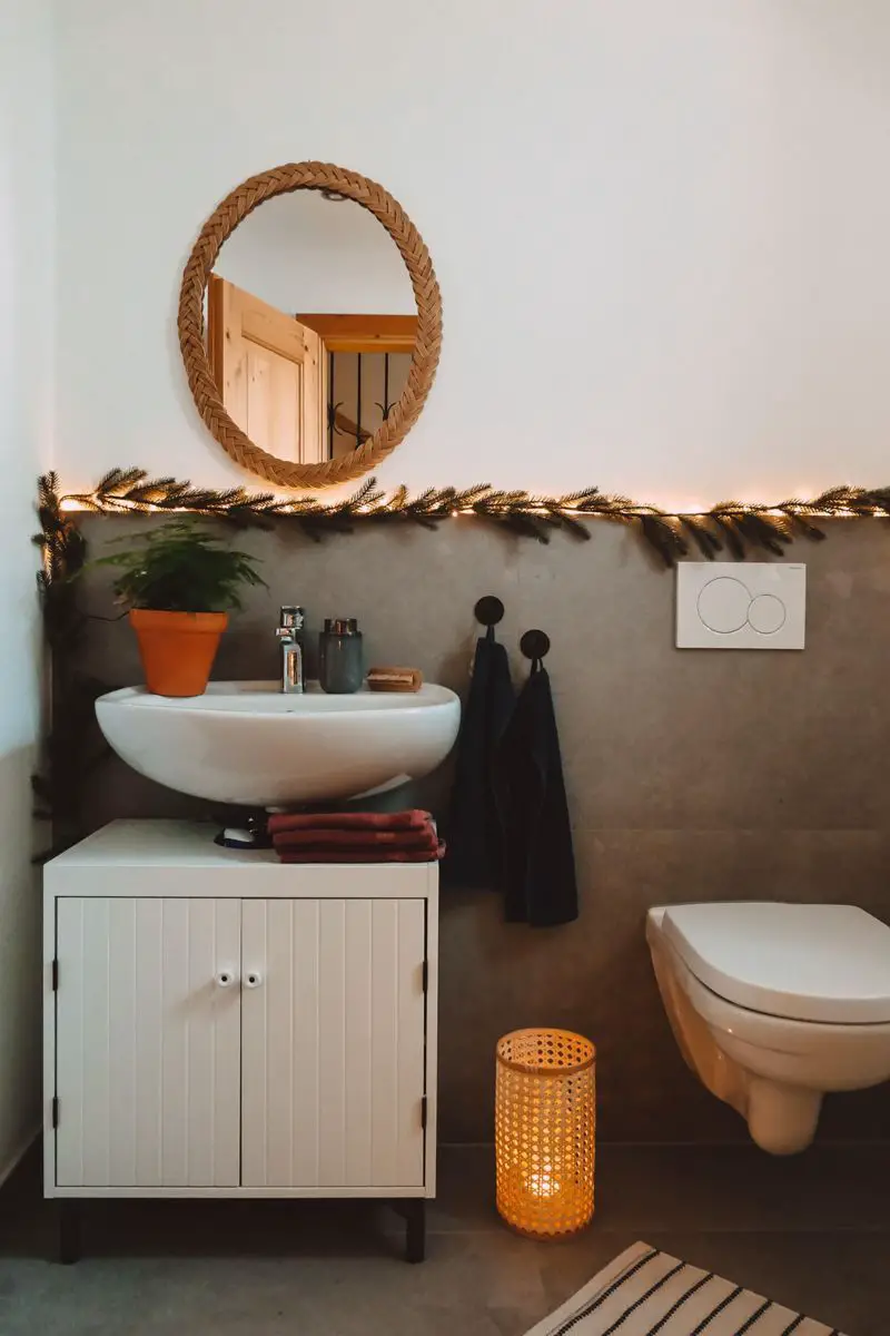 Pine Garland and Fairy Lights Adorning a Modern Bathroom Wall — Christmas Bathroom Decor