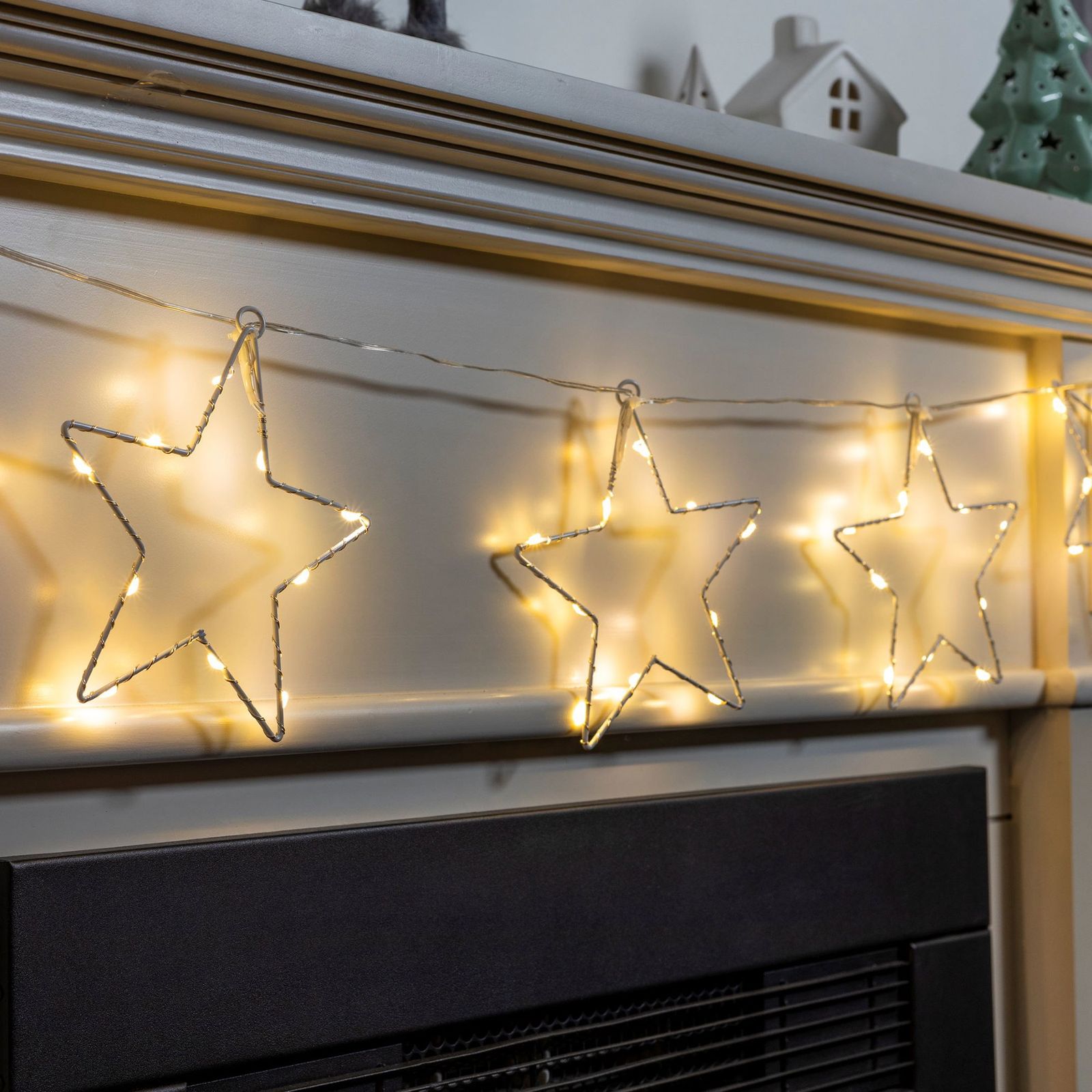 Star-Shaped Wire Lights on a Mantelpiece — Christmas Fairy Lights Window