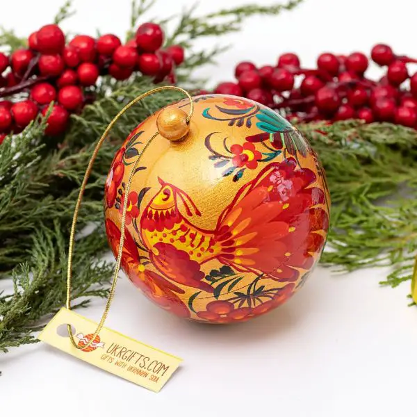 Folk Art Gold Ornament with Red Floral Motifs on Pine Branches Folk Art Gold Ornament with Red Floral Motifs on Pine Branches — Red and Gold Christmas Tree