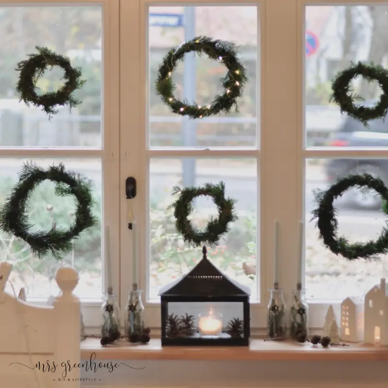 Arrangement of Six Small Pine Wreaths with Cozy Window Sill Decor Arrangement of Six Small Pine Wreaths with Cozy Window Sill Decor — Christmas Window Wreaths