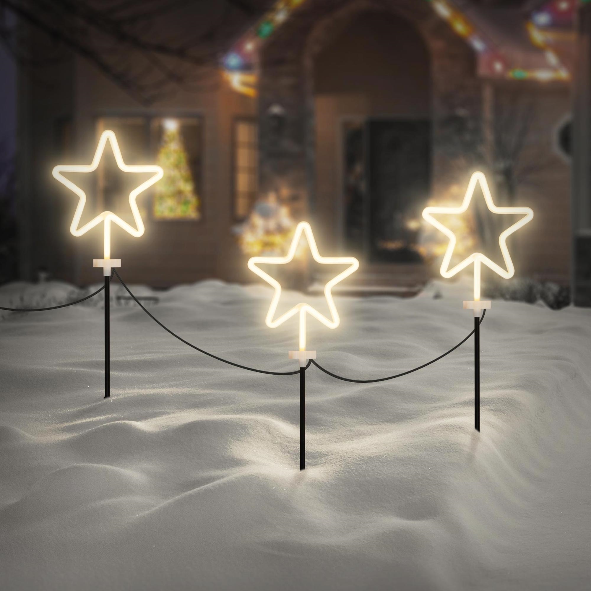 Illuminated Neon Star Lights in a Snowy Yard — Christmas Yard Decor