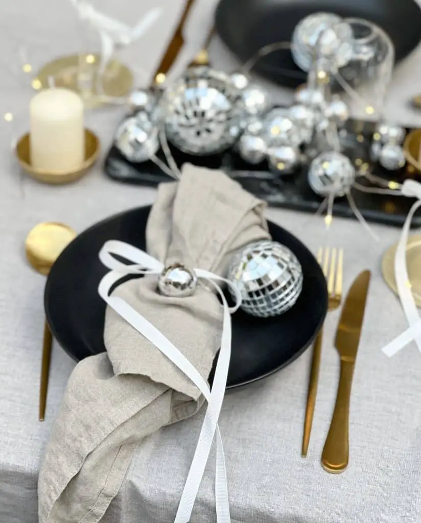 Modern Black and Beige Setting with a Miniature Disco Ball Detail Modern Black and Beige Setting with a Miniature Disco Ball Detail — New Years Eve Table Decor