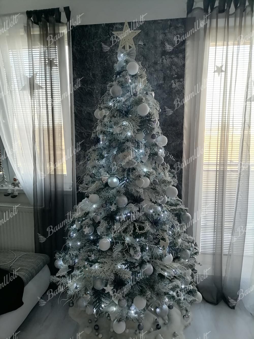 Living Room Heavily Flocked White Christmas Tree with Silver Ornaments — Christmas Tree Trends 2026