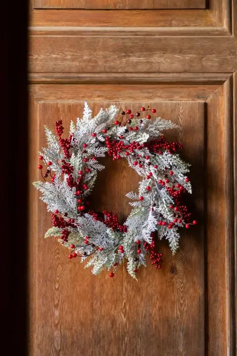 Frosted Greenery Wreath with Bright Red Berries on a Wooden Door — Christmas Wreath