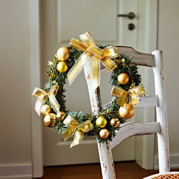 Traditional Wreath with Gold Bows and Baubles Hanging on a Chair — Christmas Wreath