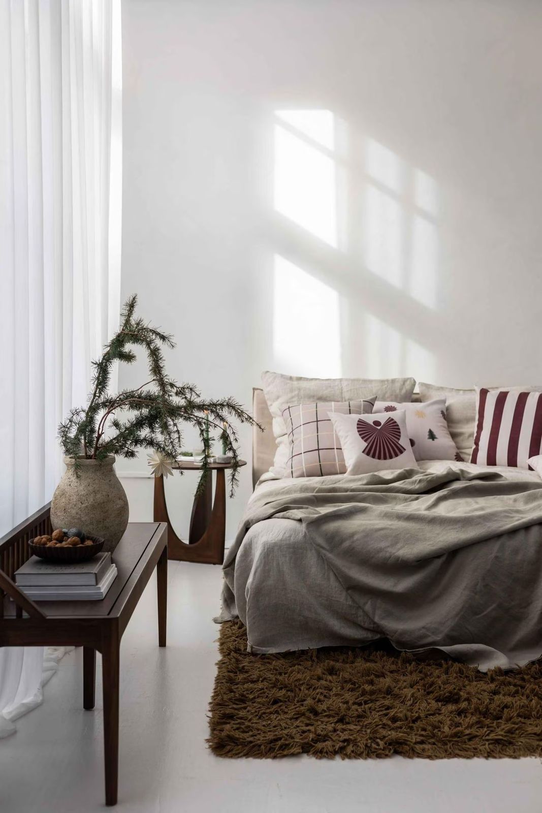 Scandi Bedroom with Evergreen Branches and Layered Linens — Christmas Bedroom Decor