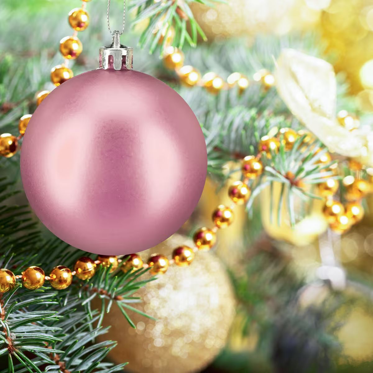 Close-up of a Pink Bauble with Gold Bead Garland — Pink and Gold Christmas Tree