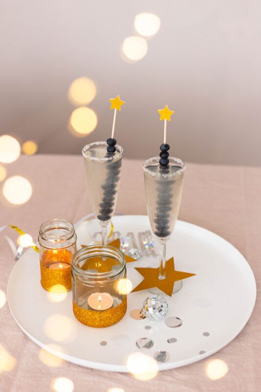 Elegant Champagne Glasses Garnished with Blueberries and Star Picks Elegant Champagne Glasses Garnished with Blueberries and Star Picks — New Years Eve Party Decor
