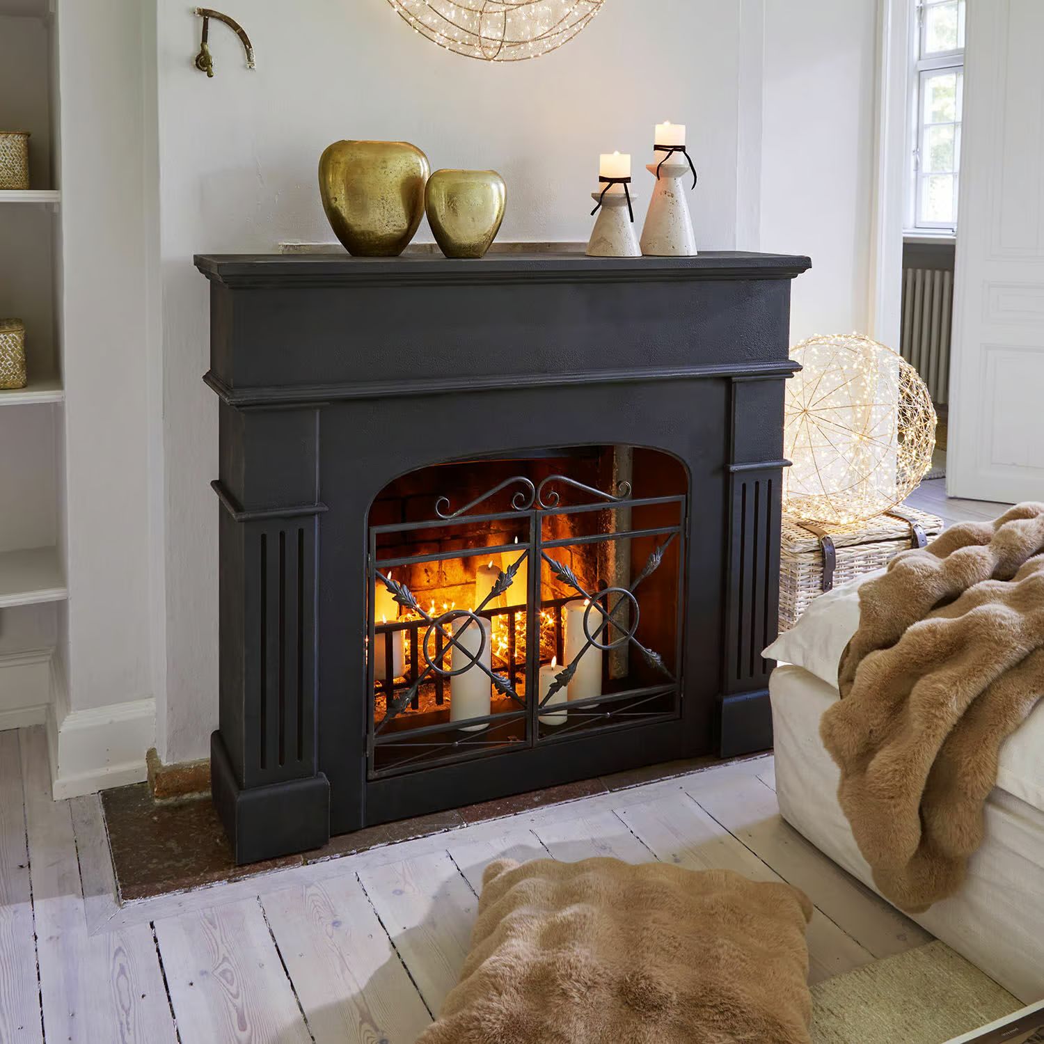 Country Style Black Fireplace with Gold Vases and Fur Throw — Christmas Fireplace Decor