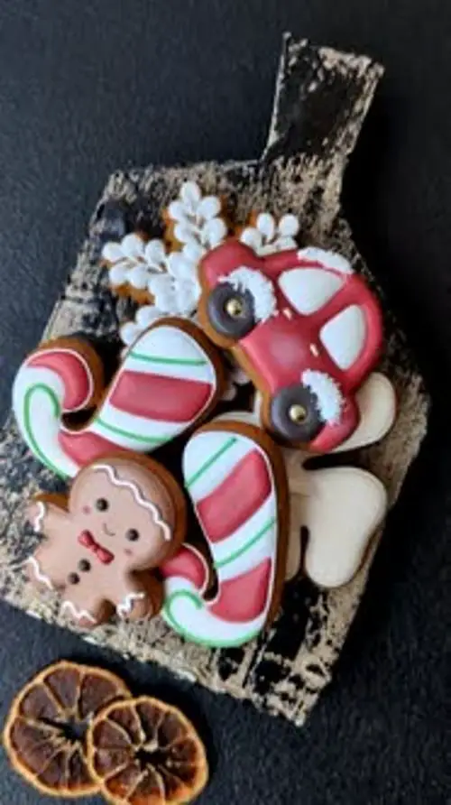 Festive Gingerbread Cookies and Candy Canes on Wooden Board Festive Gingerbread Cookies and Candy Canes on Wooden Board — Gingerbread Christmas Decor