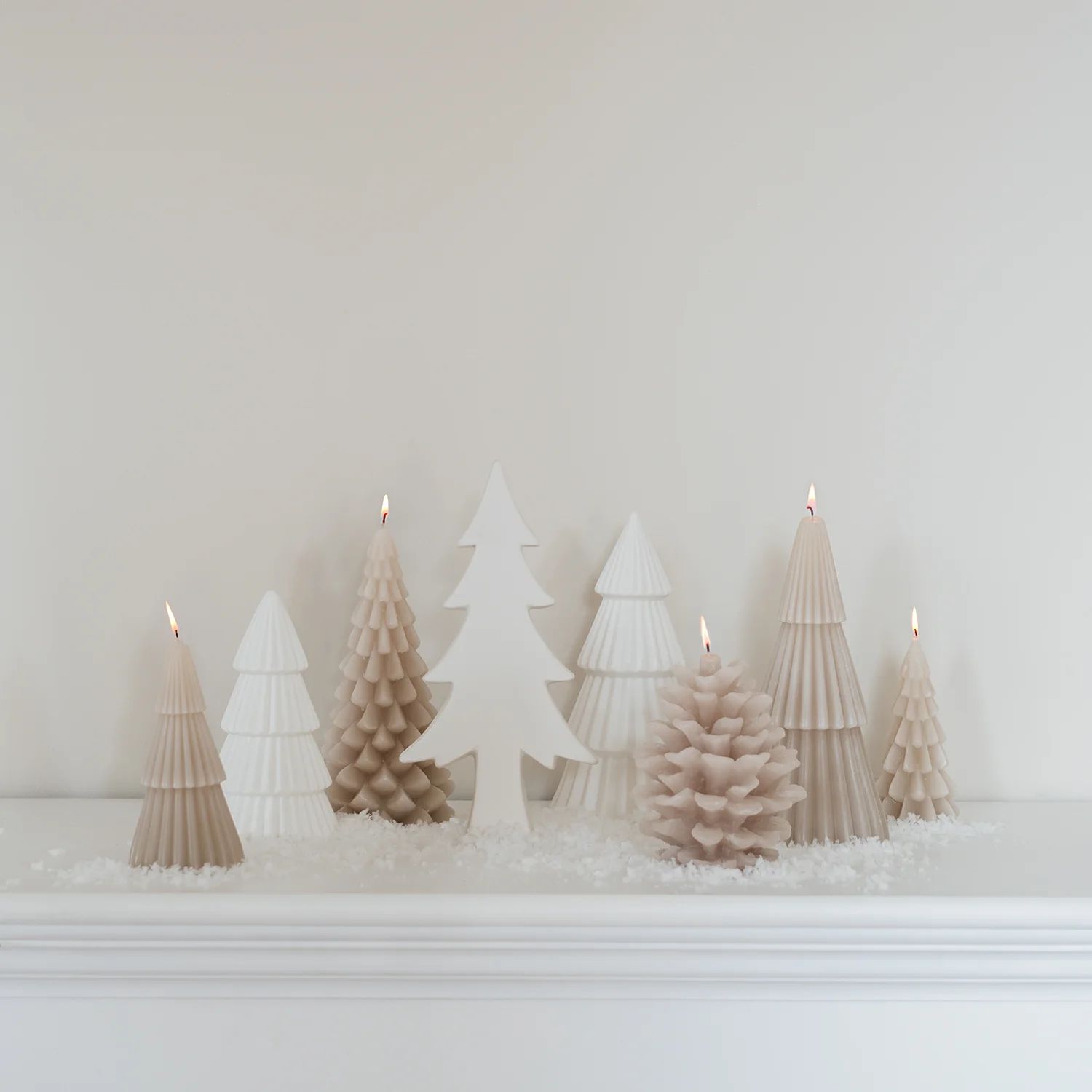 Serene White and Beige Tree-Shaped Candles on a Mantelpiece Serene White and Beige Tree-Shaped Candles on a Mantelpiece — White Christmas Tree Decor