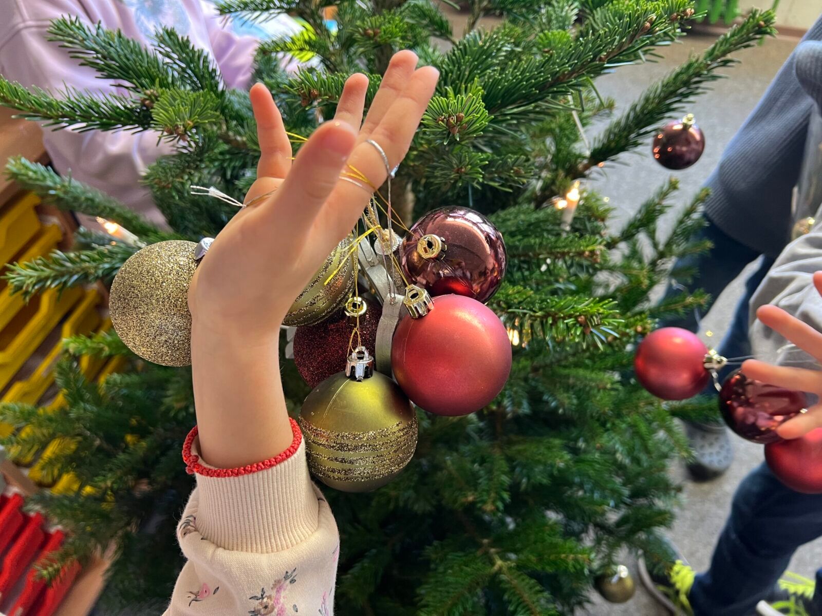 Close-Up of Children Decorating a Christmas Tree Close-Up of Children Decorating a Christmas Tree — Christmas Classroom Decor